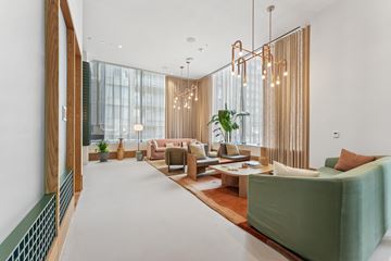 Arlington apartment for rent - A modern living room with a green sofa and a wooden floor.