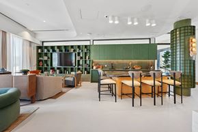 Arlington apartment for rent - A modern kitchen with green cabinets and a dining table set for four.