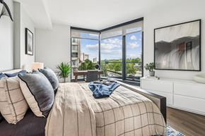 Arlington apartment for rent - A bedroom with a large bed and a view of the city.