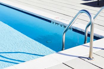 Sparkling rooftop pool with sundeck and private cabanas