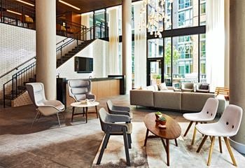 Double-height clubroom overlooking a lush private green space