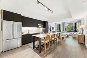 Arlington apartment for rent - a kitchen and dining room with a white table and wooden chairs