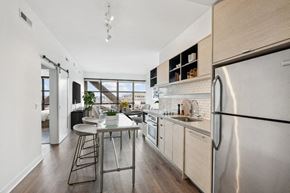 Washington apartment for rent - a kitchen with stainless steel appliances and a small table