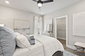 Madison apartment for rent - A bedroom with a large bed and a ceiling fan at Town Madison, Madison, AL, 35758