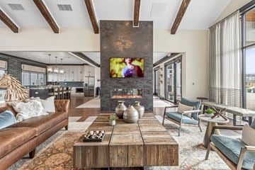 Madison apartment for rent - A modern living room with a wooden coffee table and a flat screen TV mounted on the wall.