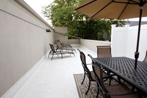 Denver apartment for rent - A patio with a table and chairs under an umbrella.