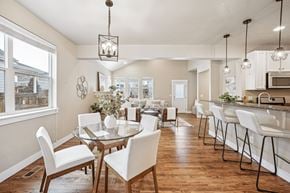 Denver townhouse for rent - A dining room with a glass table and white chairs.