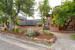 Boulder condo for rent - the front yard of a house with a sidewalk and trees