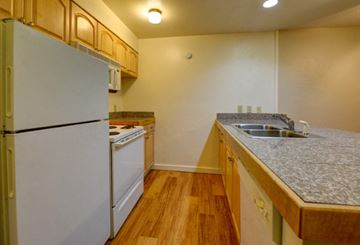 Boulder condo for rent - a kitchen with a stove refrigerator and a sink