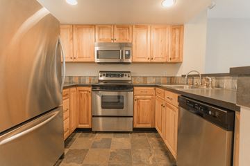 Boulder apartment for rent - A kitchen with wooden cabinets and stainless steel appliances.