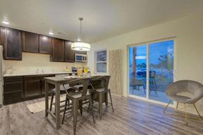 Greeley apartment for rent - a kitchen with a breakfast bar and a sliding glass door leading to a patio