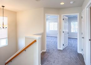 Thornton apartment for rent - A room with a carpeted floor and a chandelier hanging from the ceiling.