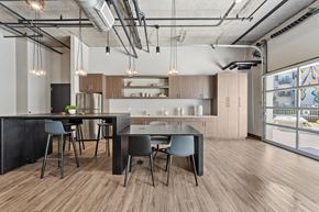 Aurora apartment for rent - A modern kitchen with a dining table and chairs.