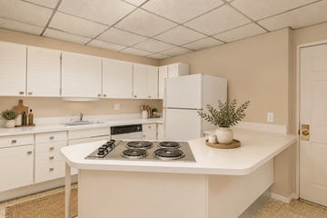 Denver apartment for rent - A kitchen with white cabinets and a white countertop.