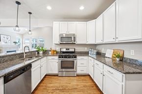 Denver townhouse for rent - A kitchen with white cabinets and a granite countertop.
