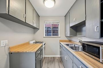 Denver apartment for rent - A kitchen with a wooden counter top and stainless steel appliances.