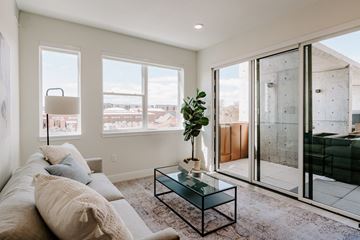 Lakewood apartment for rent - A living room with a glass coffee table and a view of the outside.