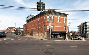Denver apartment for rent - A street view with a traffic light and a building.