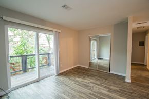 Boulder apartment for rent - an empty living room with sliding glass doors to a balcony