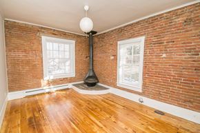 Boulder apartment for rent - an empty living room with a brick wall and wood floors