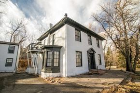 Boulder apartment for rent - a white house with black windows and a sidewalk