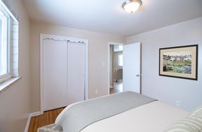 Denver apartment for rent - A bedroom with a bed, a window, and a painting on the wall.