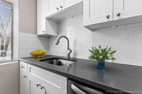 Denver apartment for rent - A kitchen with a sink and a bowl of fruit on the counter.