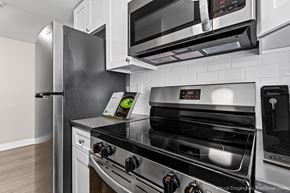Denver apartment for rent - A modern kitchen with a stainless steel refrigerator, microwave, and oven.