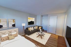 Denver apartment for rent - A bedroom with a large bed and a couch.