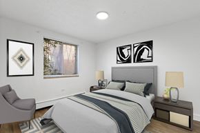 Denver apartment for rent - A bedroom with a large bed and a chair.