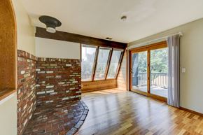 Boulder apartment for rent - A room with a brick wall and wooden flooring.