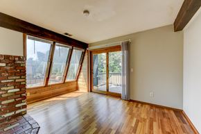 Boulder apartment for rent - A room with wooden floors and a brick column on the left side.