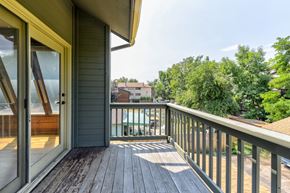 Boulder apartment for rent - A balcony with a glass door and a wooden floor.