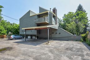Boulder apartment for rent - A grey house with a car parked in front.