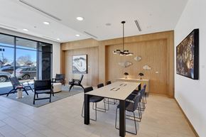 Denver apartment for rent - a dining room with a long table and chairs and a large window