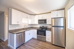 Denver apartment for rent - A kitchen with white cabinets and stainless steel appliances.