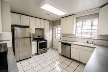 Edgewater apartment for rent - A kitchen with white cabinets and a stainless steel refrigerator.