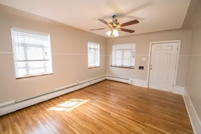 Edgewater apartment for rent - A room with a ceiling fan and wooden flooring.