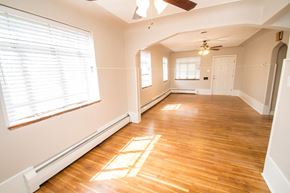 Edgewater apartment for rent - A room with wooden floors and a ceiling fan.