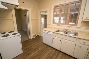 Denver apartment for rent - A small kitchen with a washing machine and a dishwasher.