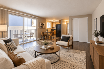 Denver apartment for rent - A living room with a white couch and a coffee table.