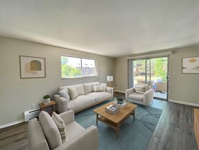 Denver apartment for rent - A living room with a couch, chair, and coffee table.