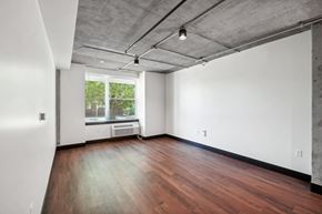 Greeley apartment for rent - an empty living room with wood floors and a window