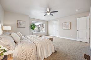 Denver townhouse for rent - A bedroom with a large bed and a ceiling fan.