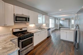 Denver apartment for rent - a kitchen with white cabinets and stainless steel appliances
