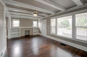 Denver apartment for rent - an empty living room with a large window and wood floors