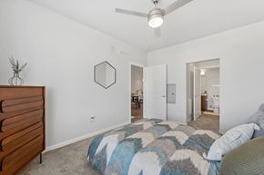 Aurora apartment for rent - A bedroom with a bed and a dresser.