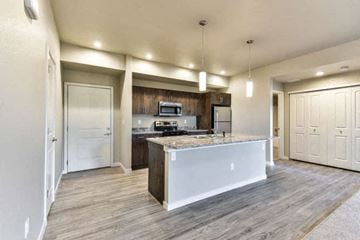 Fort Collins apartment for rent - a large kitchen with a counter top and a refrigerator