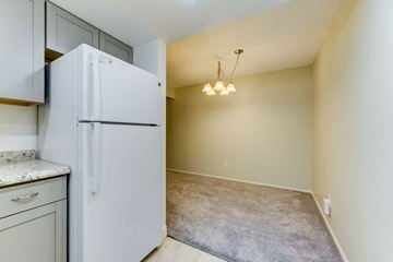 Boulder condo for rent - A white refrigerator stands in a kitchen next to a counter.