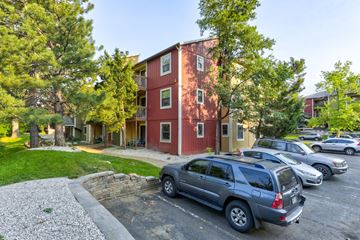 Boulder condo for rent - A red building with a grey car parked in front.